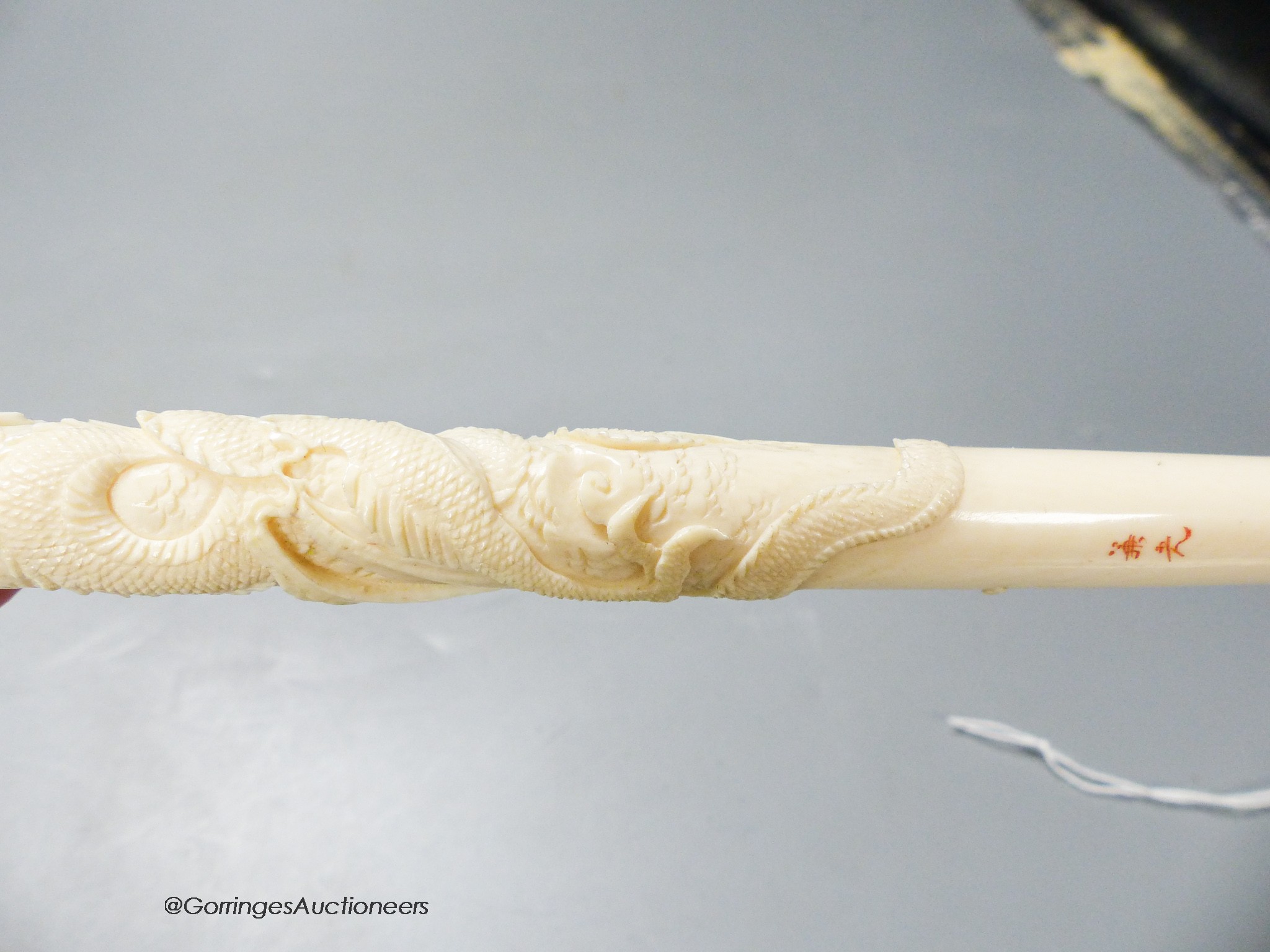 A Japanese ivory 'dragon' parasol handle, early 20th century, signed